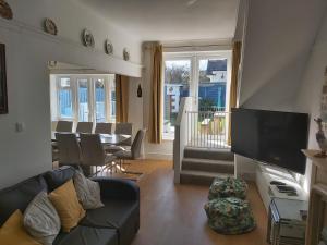 a living room with a couch and a table at Captain's Lodge in Sandown