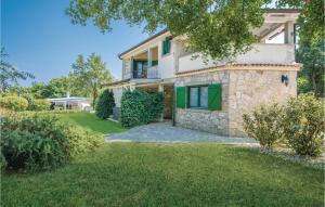 an image of a house with a yard at Amazing Home In Malinska With 2 Bedrooms, Wifi And Outdoor Swimming Pool in Malinska