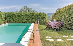 a table and chairs next to a swimming pool at Tutignano in Pontassieve