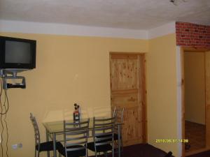 a dining room with a table and chairs and a television at Rekreační dům Slavonice in Slavonice