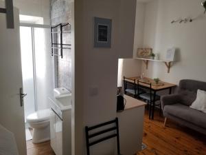 a small living room with a couch and a table at Elvas GuestHouse in Elvas