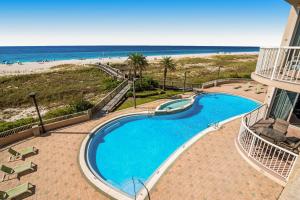 a swimming pool with the beach in the background at Spanish Key 204 in Perdido Key