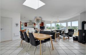 a kitchen and dining room with a table and chairs at Gorgeous Home In Tarm With Sauna in Hemmet