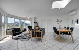a living room with a couch and a table at Gorgeous Home In Tarm With Sauna in Hemmet