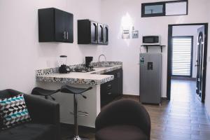 a kitchen with a refrigerator and a counter top at Departamento Mazatlán in Mazatlán