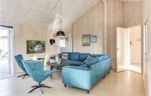 sala de estar con sofá azul y mesa en Gorgeous Home In Stege With Sauna, en Stege