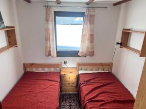 two beds in a small room with a window at Camping-in-Waabs in Waabs