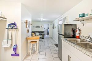a kitchen with a sink and a refrigerator at Lakeland Vacation Rental 38 Mi to Disney! in Lakeland
