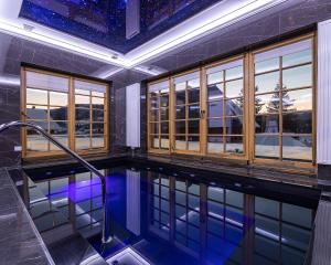 a swimming pool in a house with windows at Апарт-Готель "Панщина" in Slavske
