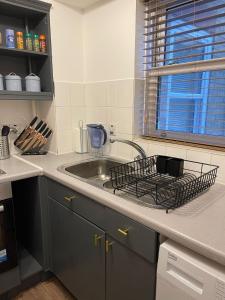 a kitchen counter with a sink and a window at Stunning Studio Flat - Free Parking - 3 min from Sutton Station in Sutton