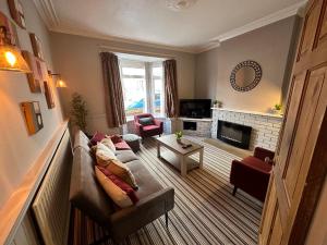 a living room with a couch and a fireplace at Number 2 Seafield - sleeps 5 - Grantham town in Lincolnshire