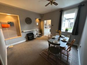a living room with a table and a dining room at Number 2 Seafield - sleeps 5 - Grantham town in Lincolnshire