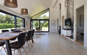 a dining room and living room with a table and chairs at Stunning Home In Humble With Kitchen in Humble