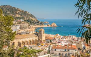 a view of a town with the ocean in the background at Amazing Apartment In Tossa De Mar With Kitchen in Tossa de Mar