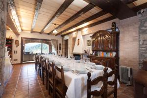 a long dining room with a long table and chairs at Mas Can Xera in Amer