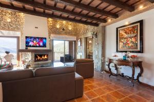 a living room with a couch and a fireplace at Mas Can Xera in Amer