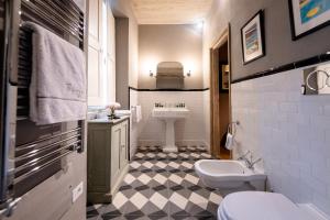 a bathroom with a sink and a toilet at Borgo Signature Rooms in Florence