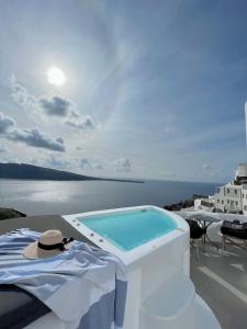 a swimming pool on the roof of a house at ArmonOia Luxury Caves in Oia +74 photos