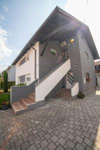 a house with a staircase in front of it at Apartman Teo in Velika Gorica