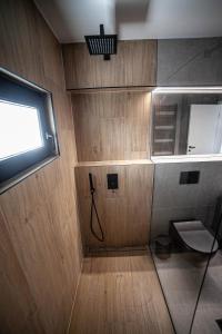 a small bathroom with a toilet and a window at Apartman Teo in Velika Gorica +14 photos