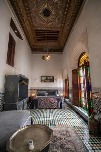a bedroom with beds and a coffered ceiling and a table at Riad Arabella Fès in Fez +65 photos