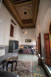 a living room with a coffered ceiling and a table at Riad Arabella Fès in Fez