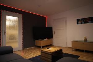 a living room with a television and a red light at Romantisches Main Erlebnis in Gemünden
