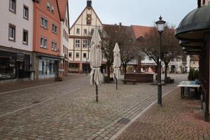 a street with umbrellas on a cobblestone street at Romantisches Main Erlebnis in Gemünden