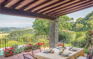 a table and chairs on a patio with a view at Vista San Lorenzo in Ampinana
