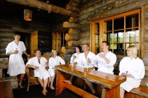 a group of people in white robes sitting around a table at Herttua Hotel and Spa in Kerimäki