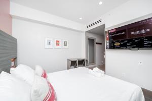 a bedroom with two beds and a flat screen tv at The Julia Hotel in Miami Beach +25 photos