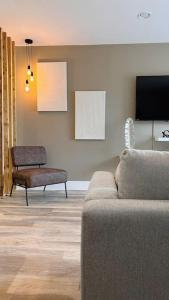 a living room with a couch and a tv at No29, Luxury Apartment near Bicester Village in Bicester