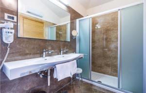 a bathroom with a sink and a shower at Beautiful Home In Turcic With Wifi in Vantačići