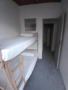 Postel nebo postele na pokoji v ubytování Hostel Gomes