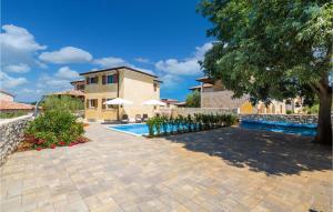 a house with a swimming pool and a tree at Stunning Home In Turcic With Kitchen in Vantačići