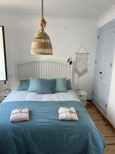a bedroom with a blue bed with two pillows on it at Casa MiraMar in Salobreña