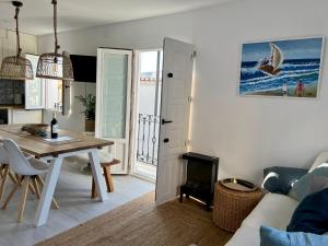 a kitchen and living room with a table and a dining room at Casa MiraMar in Salobreña