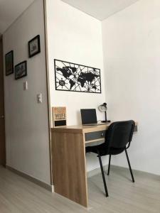 a desk with a laptop and a chair in a room at Cómodo Apartamento en Bogotá, Chapinero Central - Theatron in Bogotá +18 photos