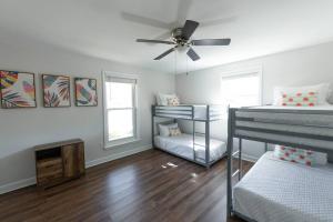 Habitación con 2 literas y ventilador de techo. en Relaxing 5-Bedroom Villa with Outdoor Oasis, en Bay Saint Louis