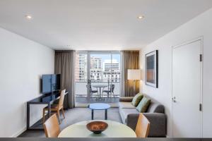 a living room with a couch and a table at Adina Apartment Hotel Wollongong in Wollongong