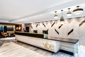 a lobby of a vico hotel with a reception desk at Vibe Hotel North Sydney in Sydney