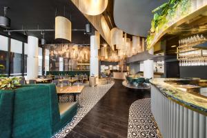 a restaurant with green furniture and a bar at Vibe Hotel Hobart in Hobart