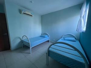 a hospital room with two beds and a blue light at Coti’s house in Río Hato