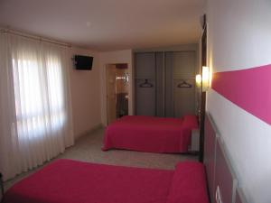 Un pat sau paturi într-o cameră la Hospedaje Luciano