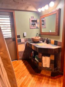 a bathroom with a sink and a mirror at Maui What a Wonderful World Bed & Breakfast in Wailea