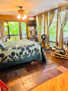 a bedroom with a bed and a large window at Maui What a Wonderful World Bed & Breakfast in Wailea