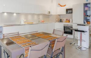 kuchnia ze stołem, krzesłami i blatem w obiekcie Gorgeous Apartment In Ajaccio w Ajaccio