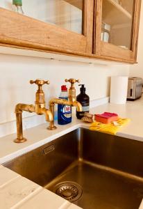 a kitchen sink with two faucets on top of it at Your Private Hoxton Apartment Sleeps 3 London Zone 1 in London