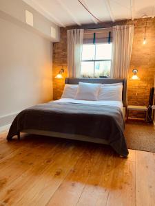 a bedroom with a large bed with a large window at Your Private Hoxton Apartment Sleeps 3 London Zone 1 in London