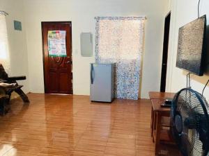 a living room with a refrigerator in the middle of a room at Jeremias Transient Patar Bolinao near WhiteBeach LightHouse in Bolinao